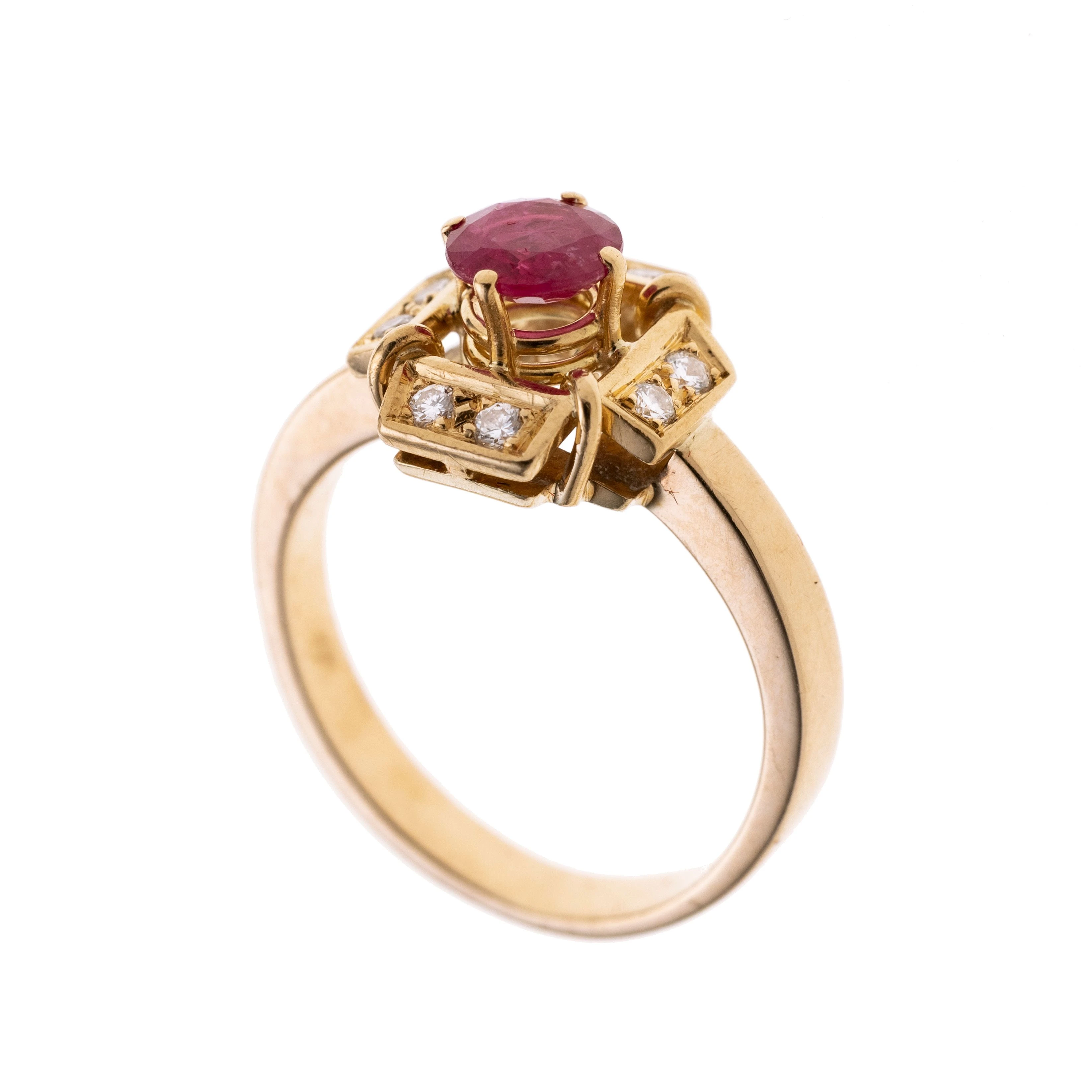 Ein kreuzförmiger Ringkopf besetzt mit acht Brillanten je ca. 0.015 ct und mit mittig leicht erhöht in Krappen ein Rubin